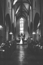 bride and groom exchanging vows in a church 