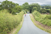 riding a bike down a rural road 