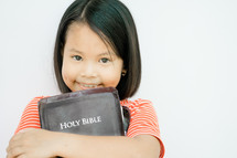 child holding a Holy Bible 