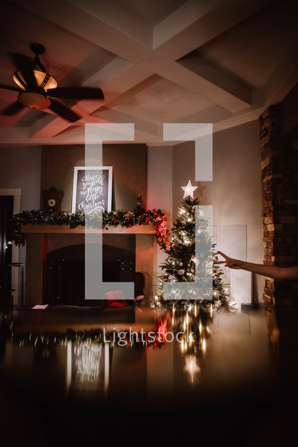 Christmas tree and Christmas lights reflecting on a wood table 