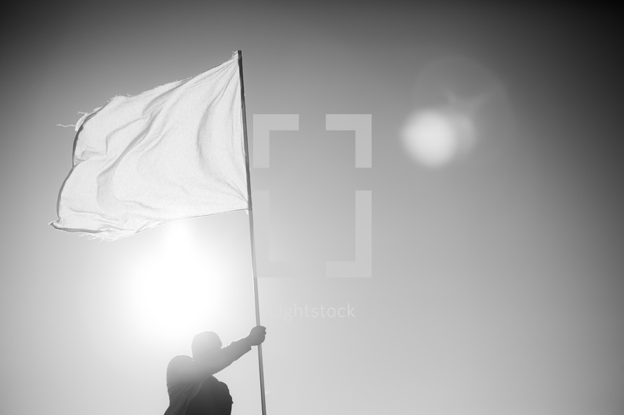man holding a white flag - surrendering