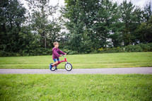a child riding a training bicycle 