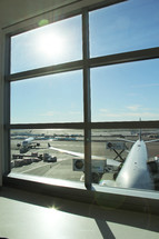 view of the tarmac out a window at an airport 
