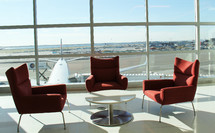 a table and chairs in an airport with a view of the tarmac 