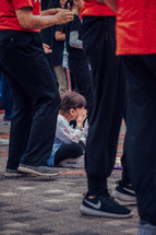 crying child sitting on the floor during a worship service 
