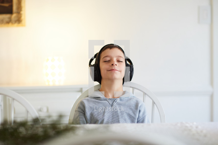 boy happily listening to headphones 