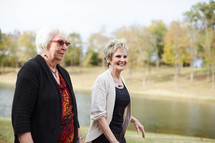 senior women walking by a pond 