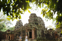 tourists in front of ruins in Angkor Wat 