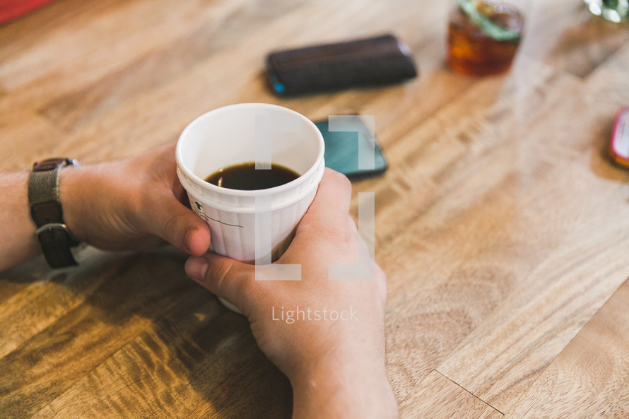 hands holding a coffee cup 