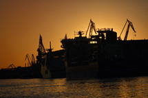 boats at a port harbor at sunset 