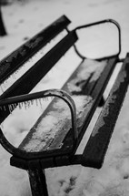 snow and ice on a winter bench 