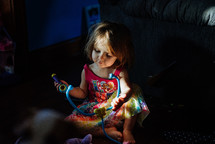 a little girl playing with toys 