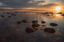 rocks in water at sunset 