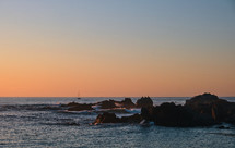 waves along a rocky shore at sunset 