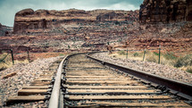 train tracks through a red rock canyon
