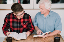Older man mentoring a younger man
