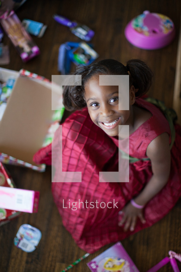 a girl child opening Christmas gifts 
