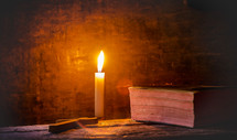 candle with cross and Bible 
