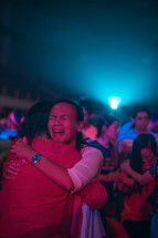 tears and hugs at a worship service 