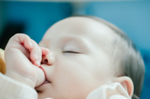 infant sucking her thumb 