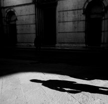 shadow on a cobblestone road 