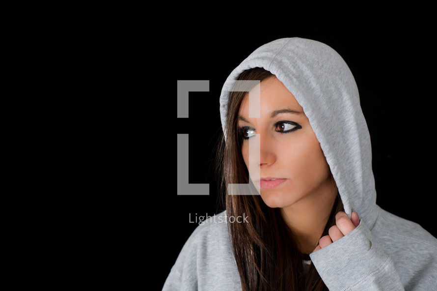 Distressed young woman in a hoodie.