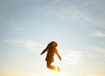 A woman jumping up in the air