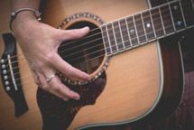 woman's hands on a guitar 
