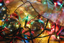 pile of ornaments, lights, and ribbons 