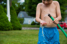 a child holding a hose 