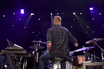 a man playing drums on stage 