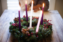 mother and son reading a Bible in front of an Advent wreath 