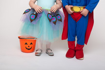 feet of children in Halloween costumes 