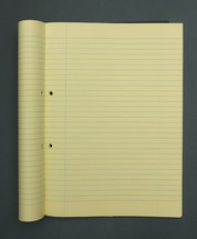 yellow lined paper in a notebook 