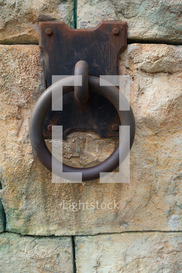 metal ring on a stone wall 