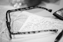 reading glasses on journal and Bible 