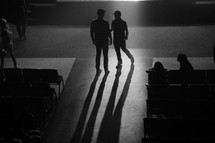 two men in conversation and shadows 