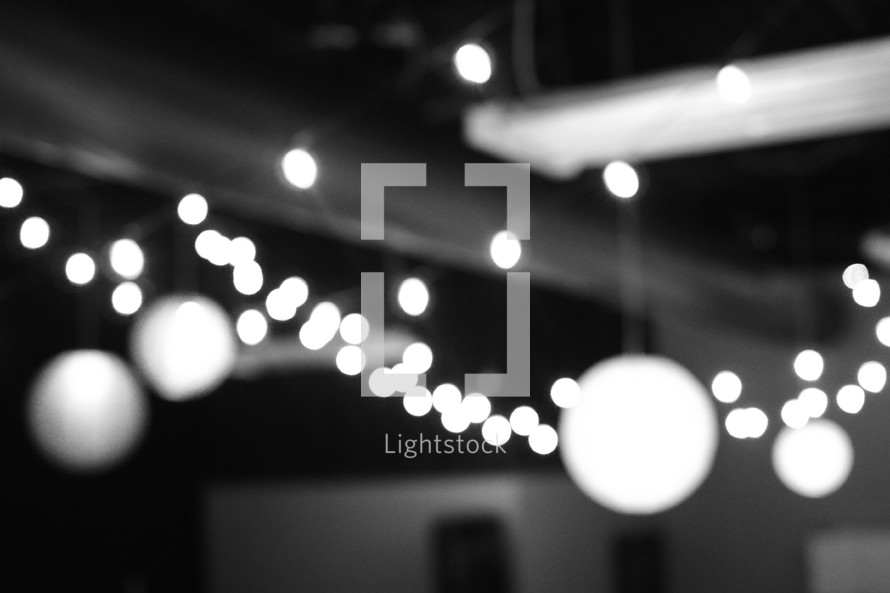 strands of white lights hanging from a ceiling