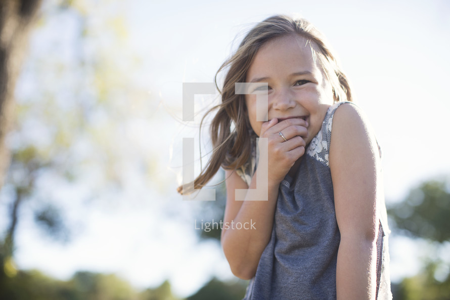 a giggling girl child outdoors 
