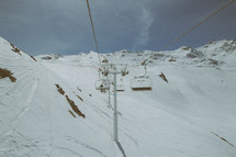 ski lift and mountain covered in snow 