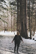 a woman standing in a forest of fresh snow 