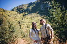 bride and groom against a mountain backdrop 
