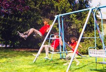 a boy on a backyard swing set