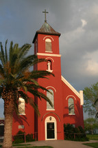 red church and palm tree 