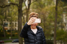 a woman taking a picture with her cellphone 
