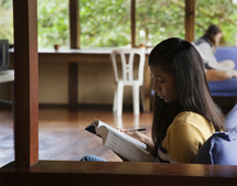 woman reading a book studying 