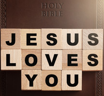 Holy Bible and word Jesus loves you 