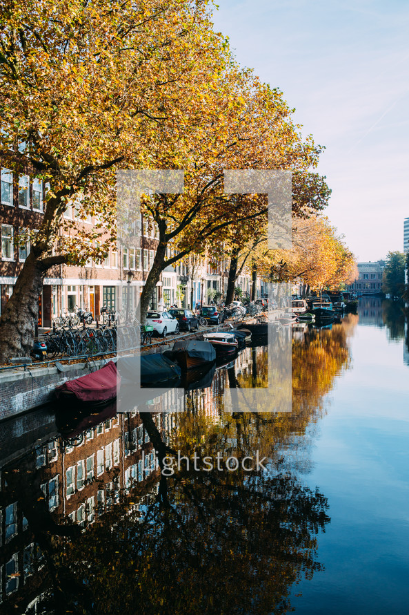 reflection of fall trees on the water in a channel in Amsterdam 