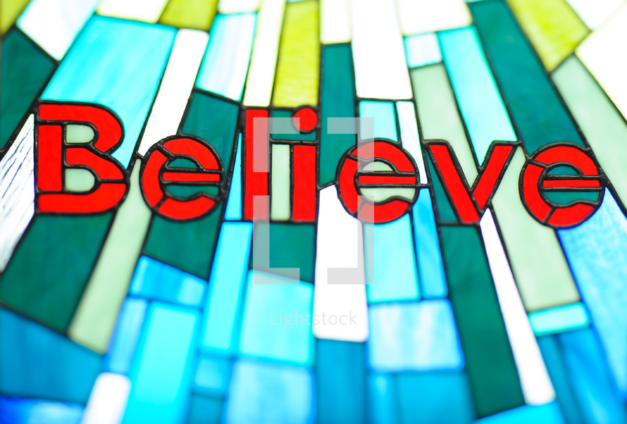 word Believe in a stained glass window 