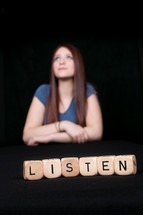 girl with headphones and the word listen